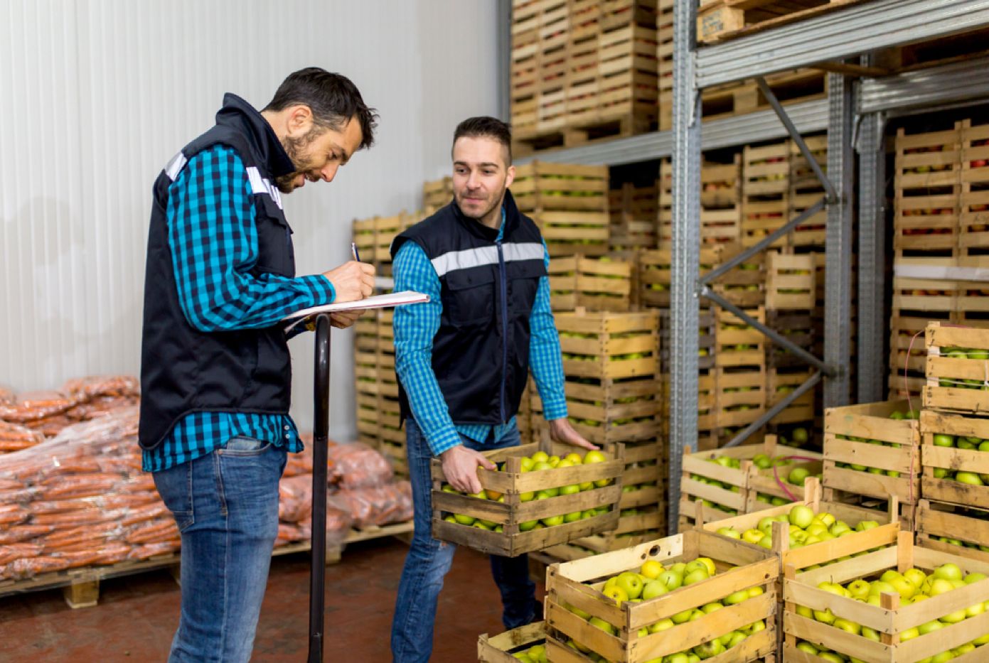 Workers checking crates of produce